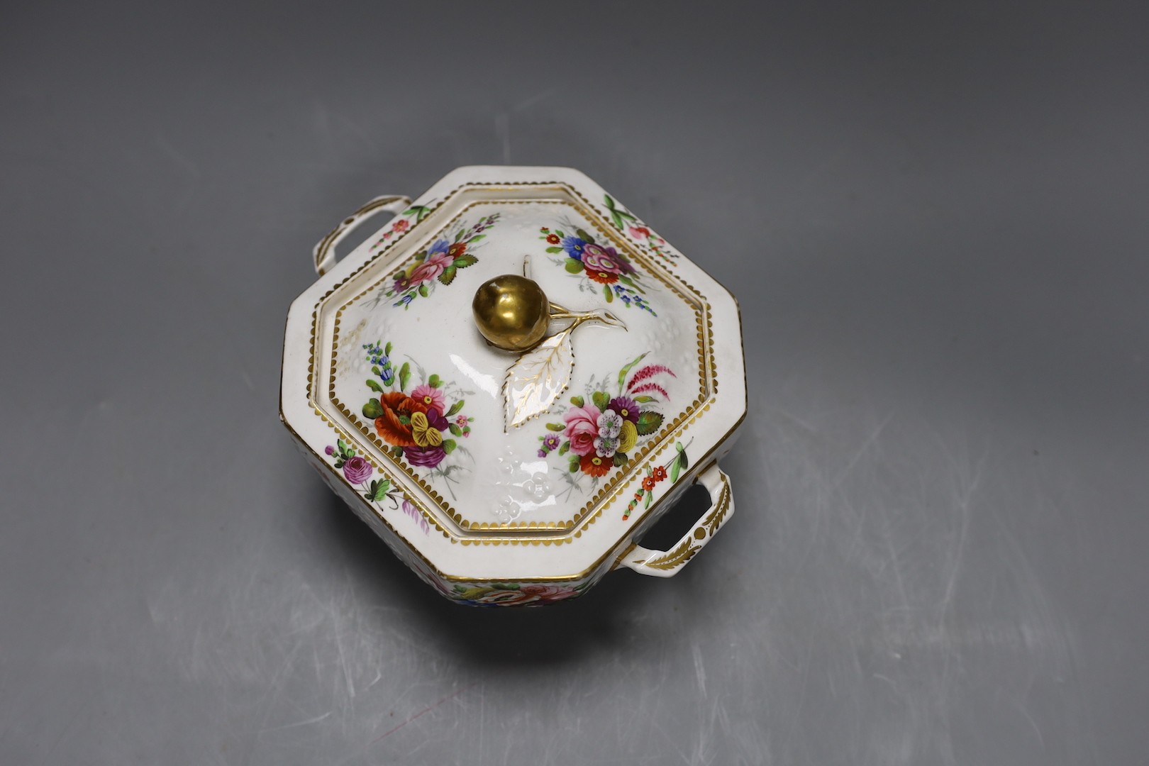 A Spode sugar box and cover of moulded form painted with flowers having a fruit finial, marked Spode 2527. 16cm